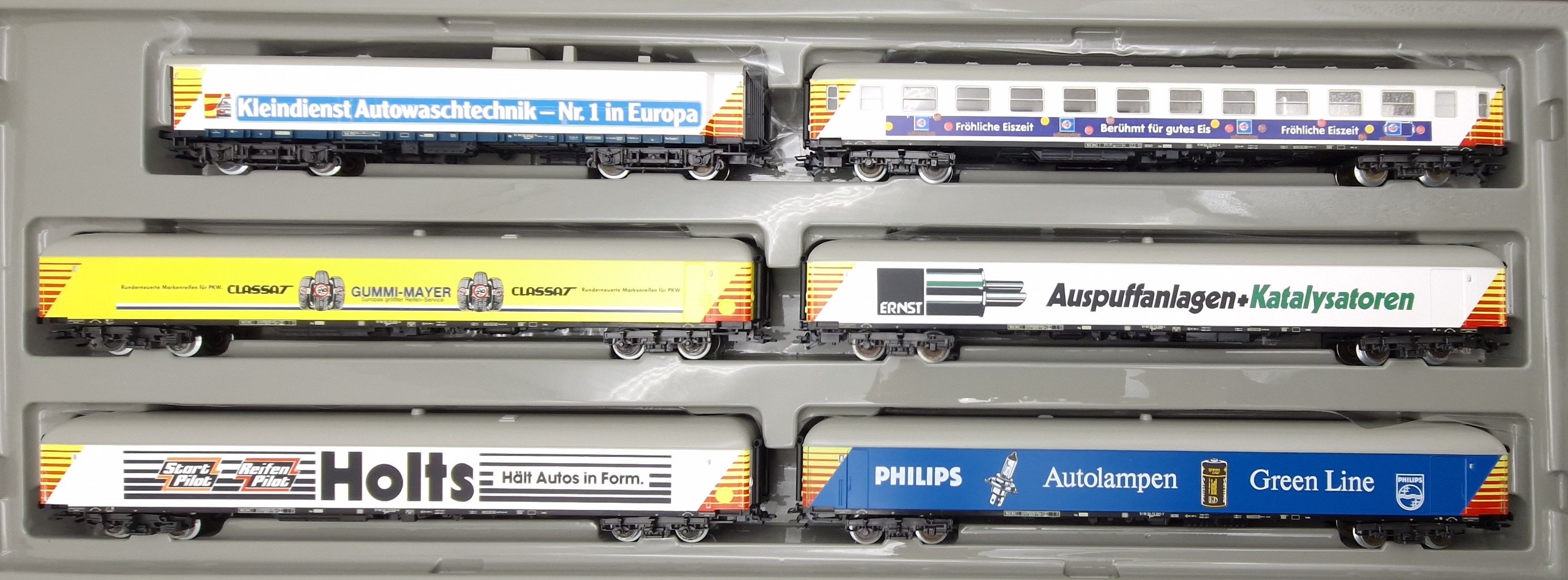 6 Wagen mit Werbebeschriftung. Kleindienst Autowaschtechnik, Philips Autolampen, Gummi-Mayer, fröhliche Eiszeit, Ernst Auspuffanlagen, Holst Start Pilot. LüP 1.575 mm